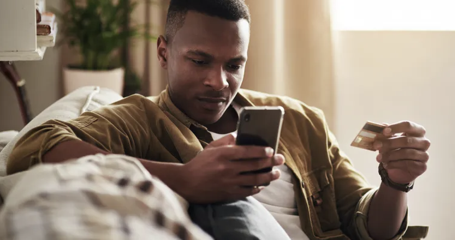 Man holding phone and credit card